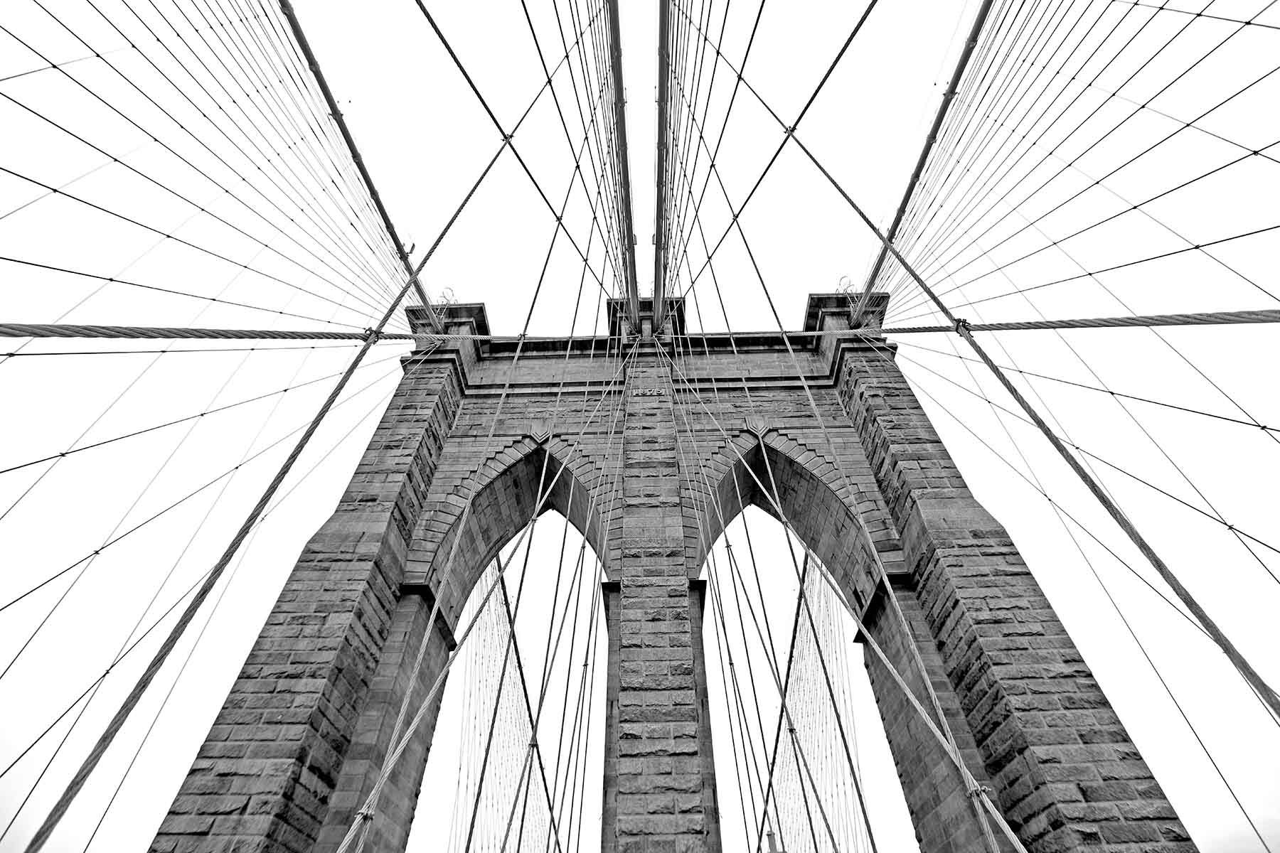 Black and white upward image of Brooklyn Bridge in NYC. Fine Art Photography AHAVART 